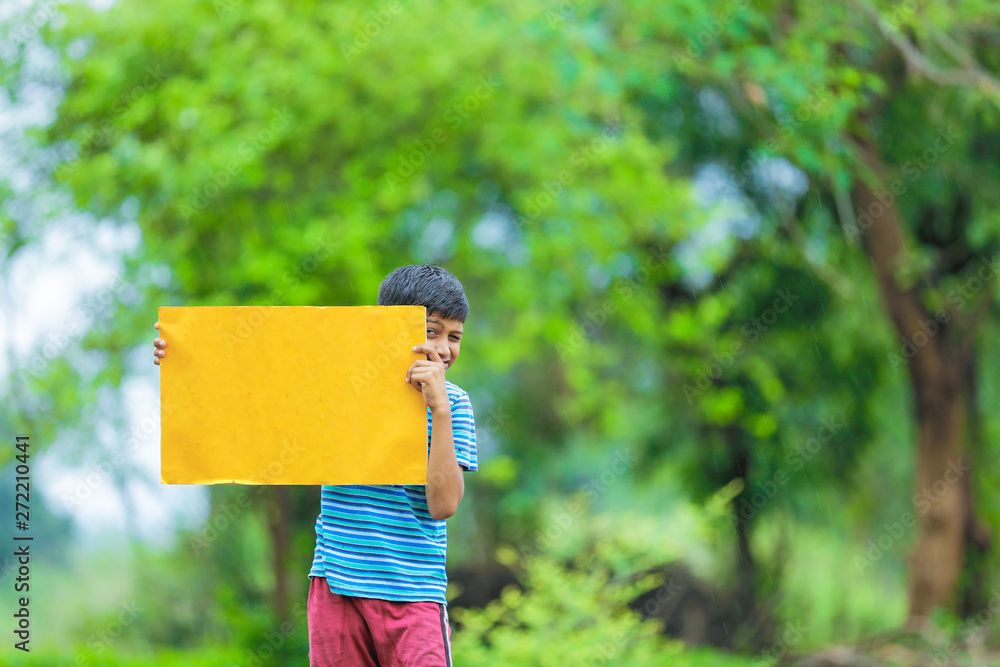  indian child holding empty poster