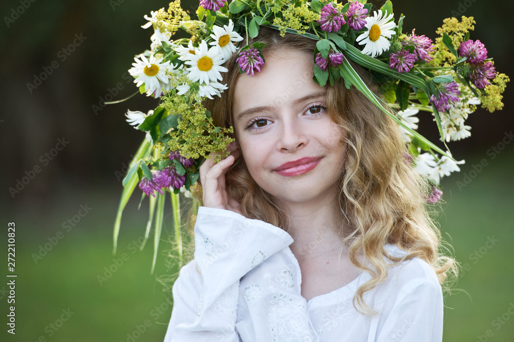 Cute smiling girl with flower wreath on the meadow at the farm. Midsummer. Earth Day. Cute smiling girl with flower wreath on the meadow at the farm. Midsummer. Earth Day.