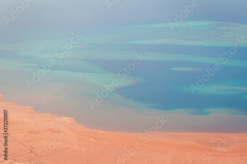 Aerial view of red sea desert coast line and colorful coral reef wih blue andturquoise waters  exotic travel destination concept with copy space
