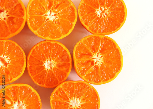 Tropical exotic fruit . Tangerines slices isolated on white table background. Summer food concept. Flat lay, top view