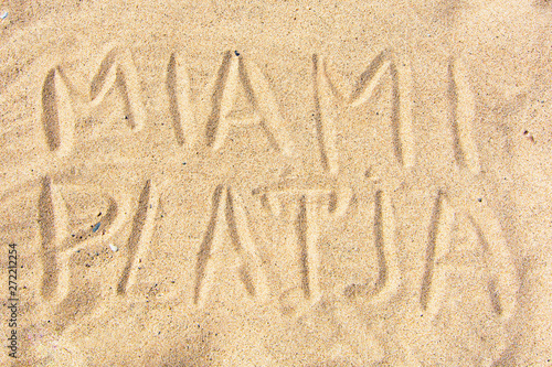 handwritten by the "Miami" on the sea sand