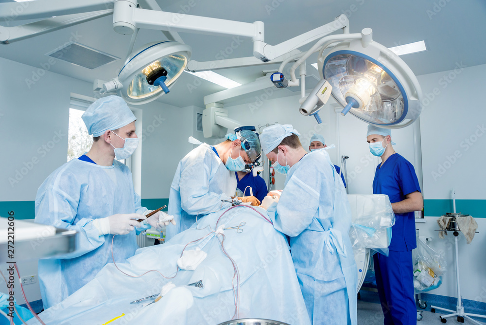 Spinal surgery. Group of surgeons in operating room with surgery equipment. Laminectomy Spinal surgery. Group of surgeons in operating room with surgery equipment. Laminectomy