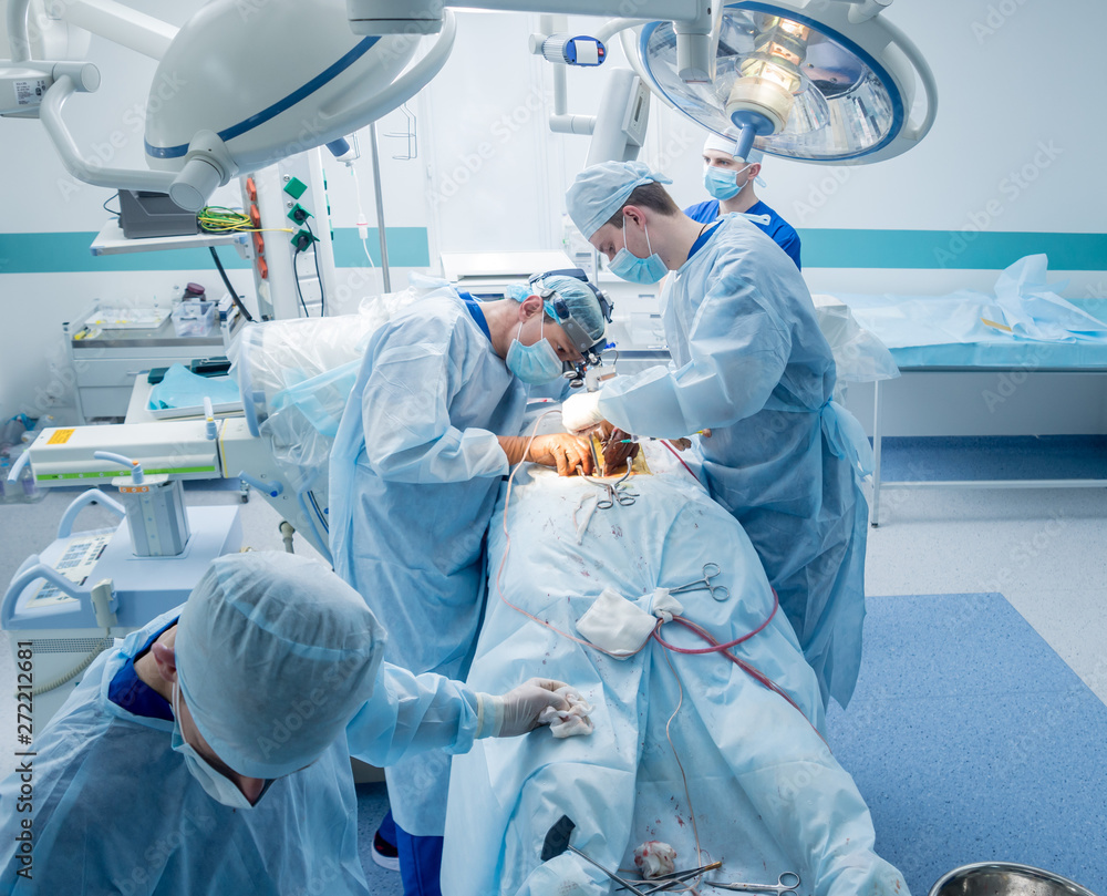 Spinal surgery. Group of surgeons in operating room with surgery equipment. Laminectomy Spinal surgery. Group of surgeons in operating room with surgery equipment. Laminectomy