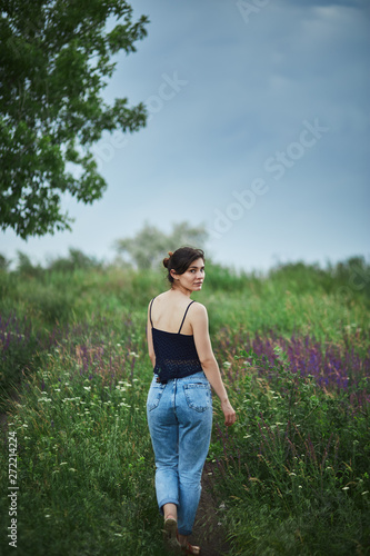 young woman in a field looking at camera