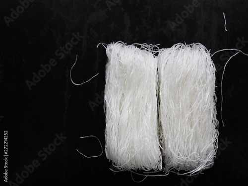 Uncooked glass noodles on black background
