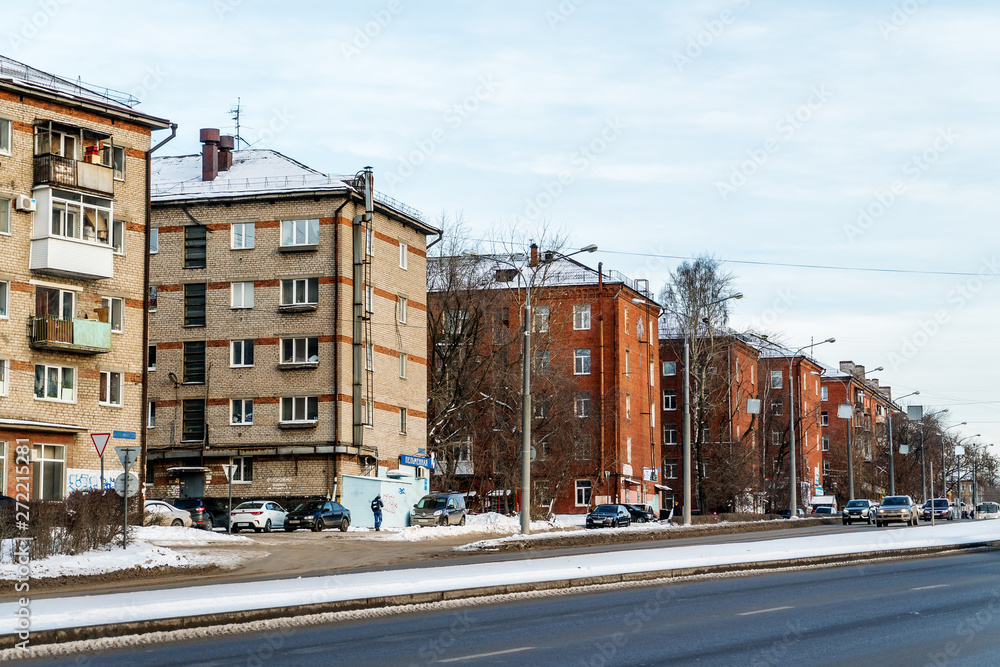 Fototapeta premium Before us is part of Chkalov Street of the city of Perm. Five-story houses of gray and red brick.