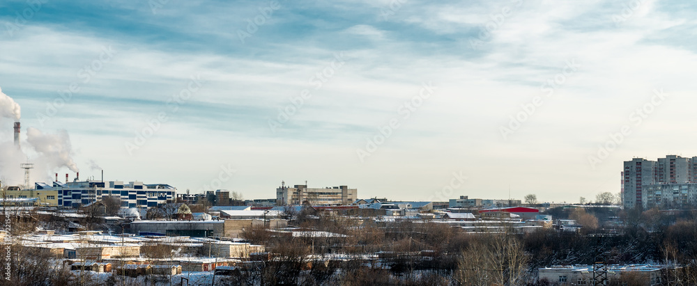 Outskirts Of Perm. In the foreground trees and a variety of low buildings. In the distance you can see Smoking chimneys, industrial buildings. On the right we see houses. Outskirts Of Perm. In the foreground trees and a variety of low buildings. In the distance you can see Smoking chimneys, industrial buildings. On the right we see houses.