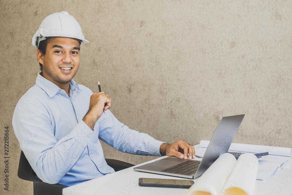 Asian civil engineer working planning project with laptop. Asian civil engineer working planning project with laptop.