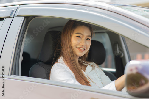 Beautiful attractive young woman smile in casual sitting in car,Diving car with confident and happiness feeling,Happy transport concept © 220 Selfmade studio