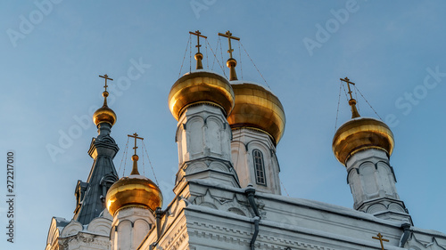 Closeup of the dome of the Holy Trinity Monastery of Stefanov in the rays of the setting sun. The faded sky and the lying snow complete the picture. photo