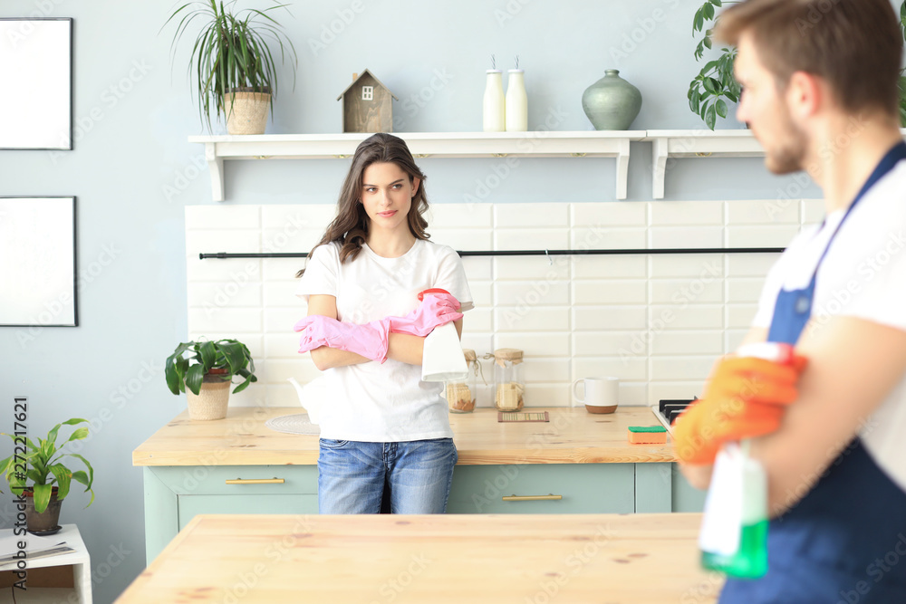 Young happy couple is having fun while doing cleaning at home. Young happy couple is having fun while doing cleaning at home.