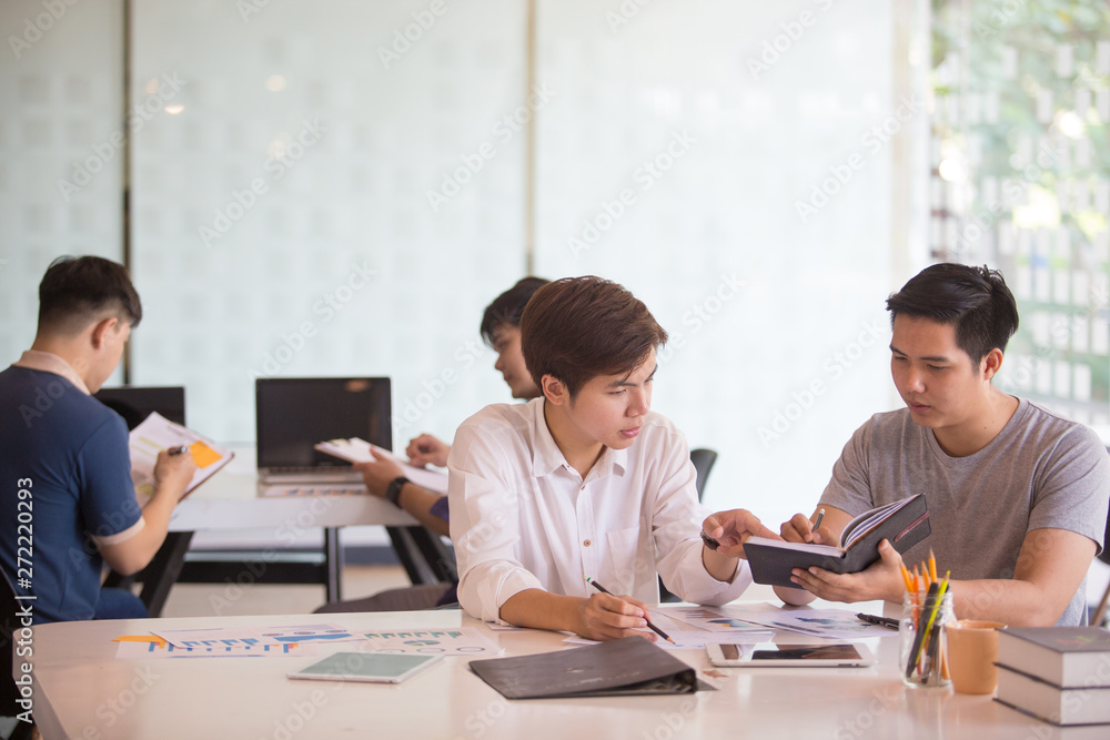 Business group or business partners discussing documents and ideas at meeting Business group or business partners discussing documents and ideas at meeting