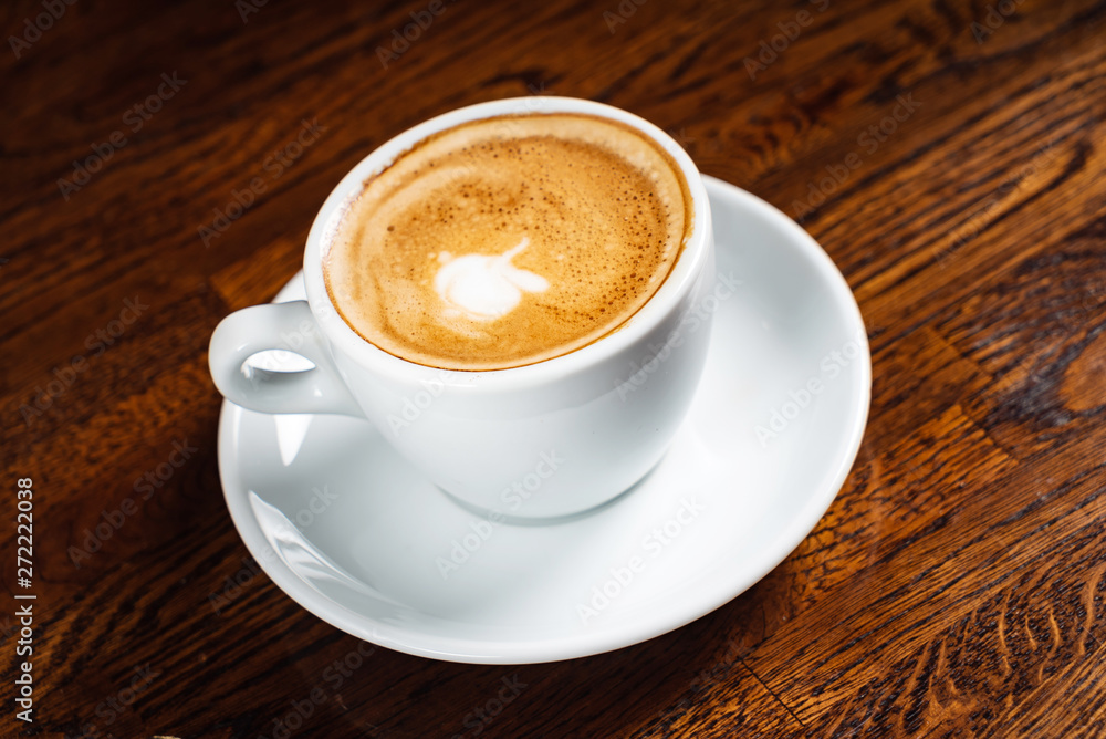 cup of cappuccino on the wooden background cup of cappuccino on the wooden background