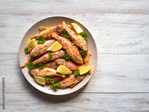 Dietary surmullet fish. Fried fish in a plate.  photo