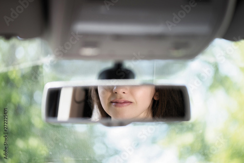 Wallpaper Mural Reflection of a smiling lips of young woman in the car rear view mirror. concept. Torontodigital.ca