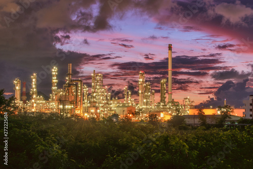 Oil​ refinery​ and​ petrochemical​ plant, refinery​ factory​ natural​ gas​ storage​ tank​ at​ yellow​ sky​ background​ © tope007