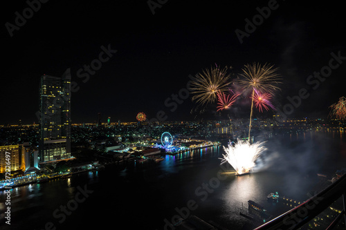 Colorful abstract new year firework on river side,bird eye view,Bangkok,Thailand,blur background © Patchamol