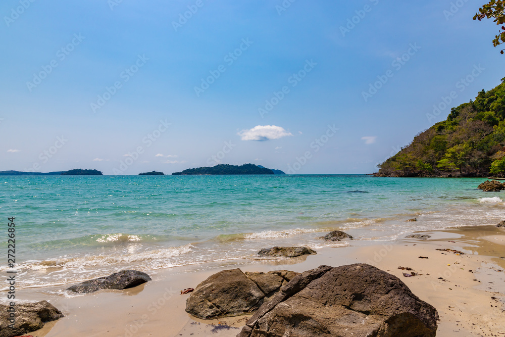 Long beach of Koh Chang island. Tropical sandy beach with palm trees and tropical forest. Thailand. Long beach of Koh Chang island. Tropical sandy beach with palm trees and tropical forest. Thailand.
