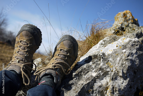 Hiking boots in mountains, overhead view, personal perspective. Italy.