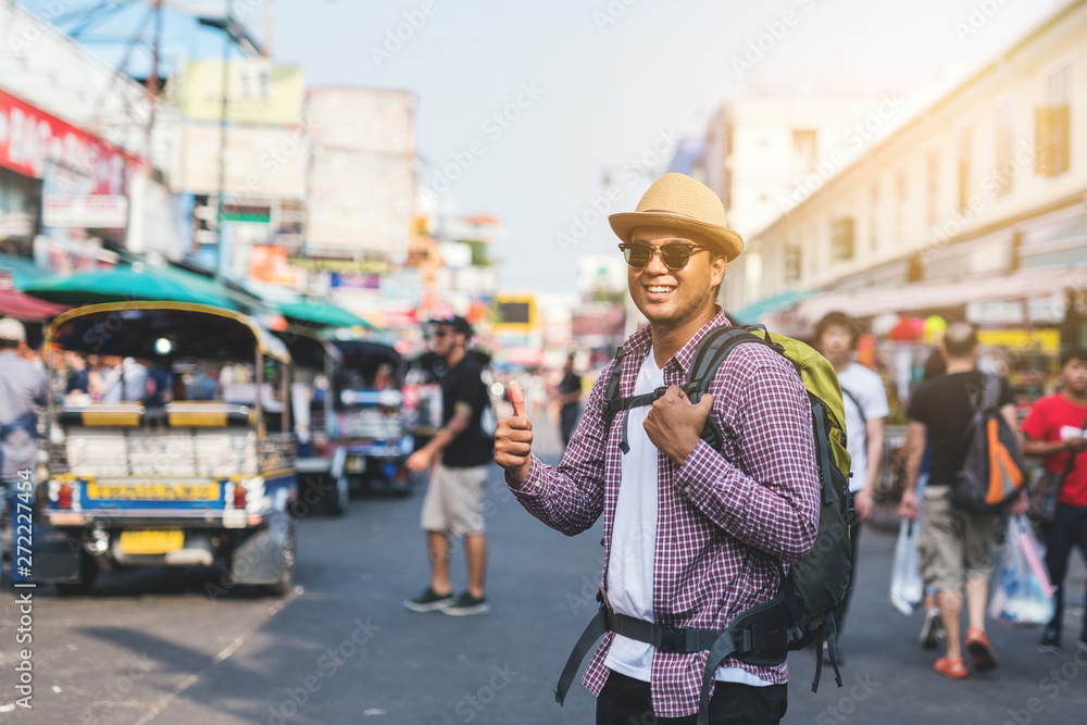 Fototapeta premium Young asian traveller man walking in Khaosan Road walking street in bangkok thailand on vacation time.