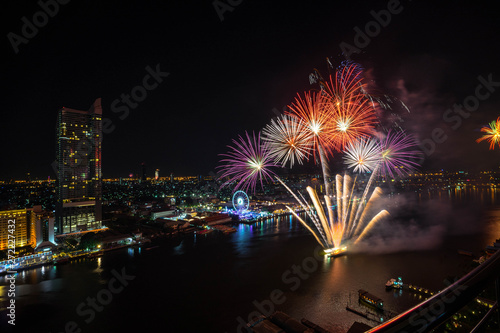 Colorful abstract new year firework on river side,bird eye view,Bangkok,Thailand,blur background