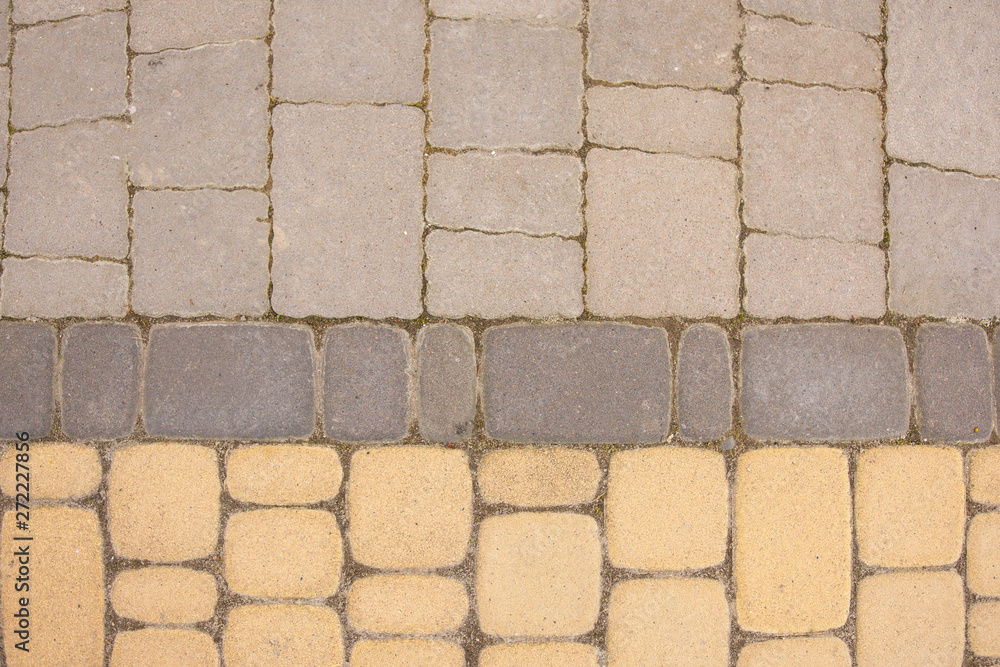Fototapeta premium Beautiful brown texture made of paving stones in a row.