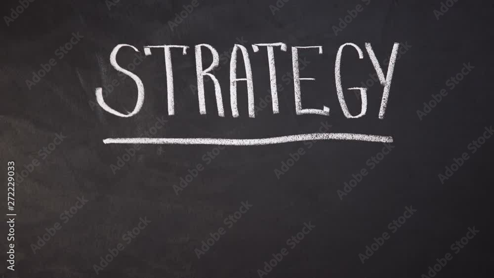 Strategy word written on blackboard, developing business, planning startup Strategy word written on blackboard, developing business, planning startup