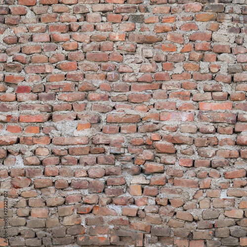 The cracked old wall of the building is made of red brick.Texture or background