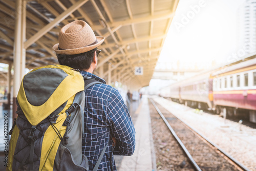 Young traveler man at platform train station. Traveling concept.