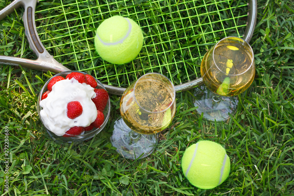 Strawberries with whipped cream, glasses with champagne and tennis  equipment on Wimbledon tournament grass. Wimbledon Grand slam celebration  concept. Top view. Stock Photo | Adobe Stock