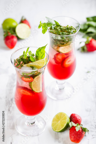 Pink lemonade with strawberries  lime  basil and mint