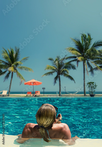 Beautiful woman relaxing in a pool at summer © Netfalls