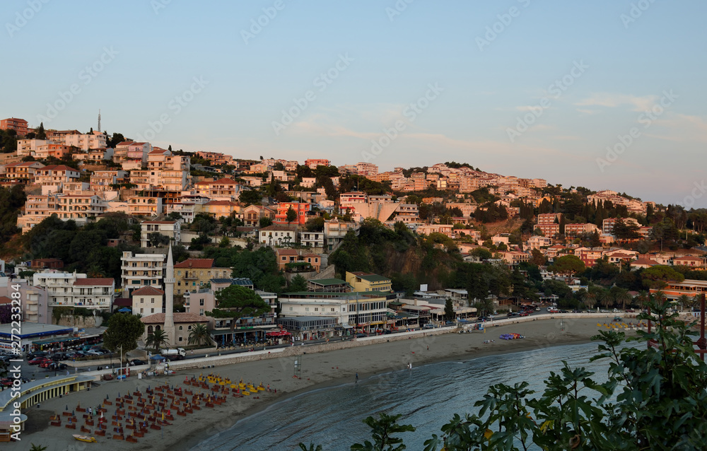 Panoramic view on coast on the old town of Ulcinj with the Kalaja castle neighboring with the central beach, Montenegro at sunset.