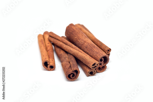 Heap of cinnamon sticks isolated on a white