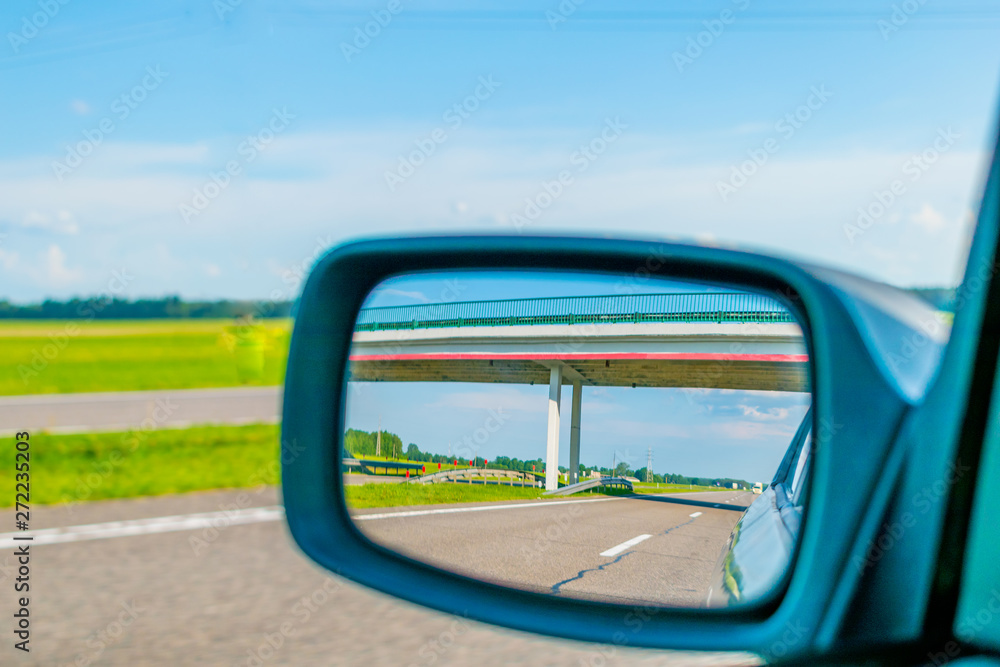 View of the road in the rear view mirror