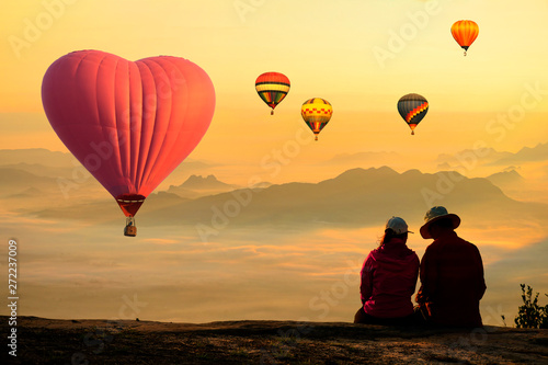 People enjoyed sunrise at the mountain top with scenic view and hot air balloon.
