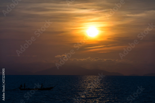 Sunrise with Sea and long tail boat with Silhouette light