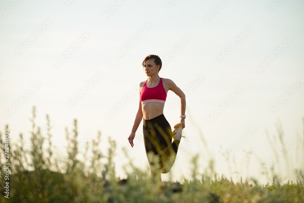 Woman Doing Stretching Outdoor. Warm up Exercise in the Summer Evening. Sport and Healthy Active Lifesyle Concept. Woman Doing Stretching Outdoor. Warm up Exercise in the Summer Evening. Sport and Healthy Active Lifesyle Concept.