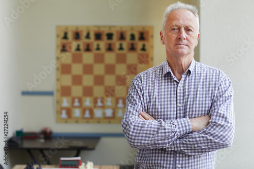 Canvas Print Famous aged male experienced grandmaster posing for pictures after winning chess