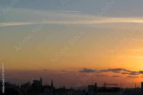 Sunset with cityscape in dark shadow, blue orange soft colors