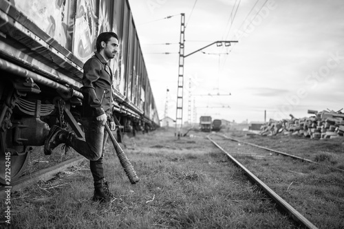 man in leather jacket and baseball bat