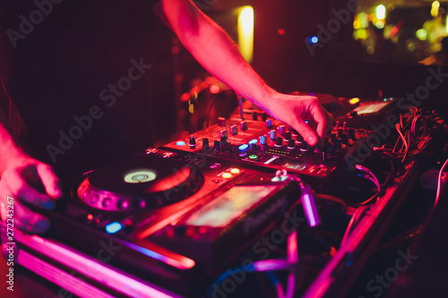 Obraz na płótnie DJ turntable console mixer controlling with two hand in concert nightclub stage