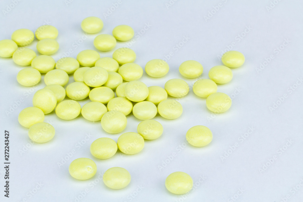 yellow pills on white background yellow pills on white background