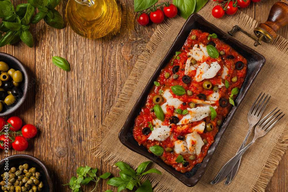 Cod in Italian in tomatoes with olives and capers. Cod in Italian in tomatoes with olives and capers.
