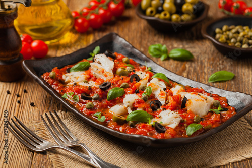 Cod in Italian in tomatoes with olives and capers.