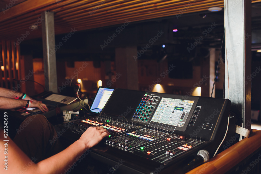 DJ turntable console mixer controlling with two hand in concert