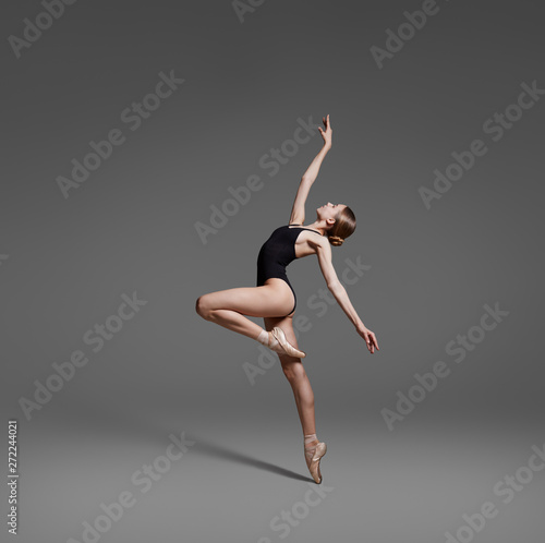 Fototapeta Naklejka Na Ścianę i Meble -  Beautiful flexible ballerina dancing in studio
