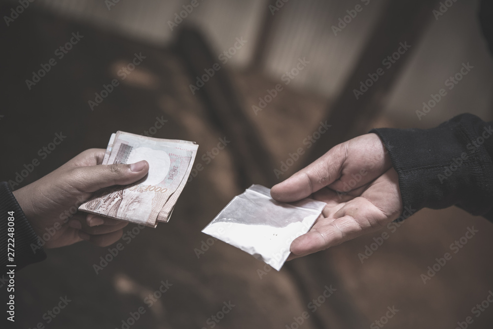 Hand of addict man with money buying dose of cocaine or heroine, close up of addict buying dose from drug dealer, drug trafficking, crime, addiction and sale concept, Hand of addict man with money buying dose of cocaine or heroine, close up of addict buying dose from drug dealer, drug trafficking, crime, addiction and sale concept,