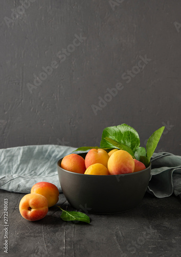 Canvas Print sweet delicious apricot on dark bowl grey table summer fresh fruit