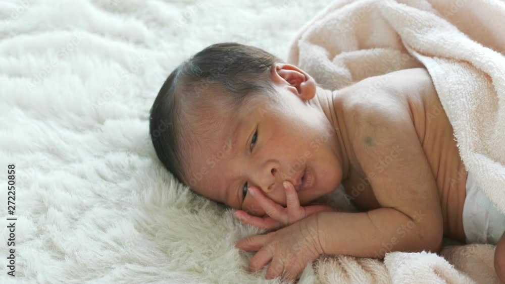 Newborn baby yawning on white bed. Newborn baby yawning on white bed.